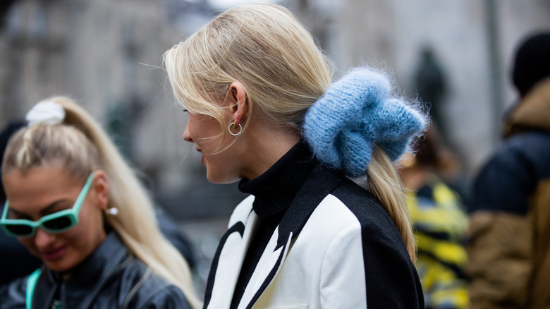 woman wearing blue sweater scrunchie