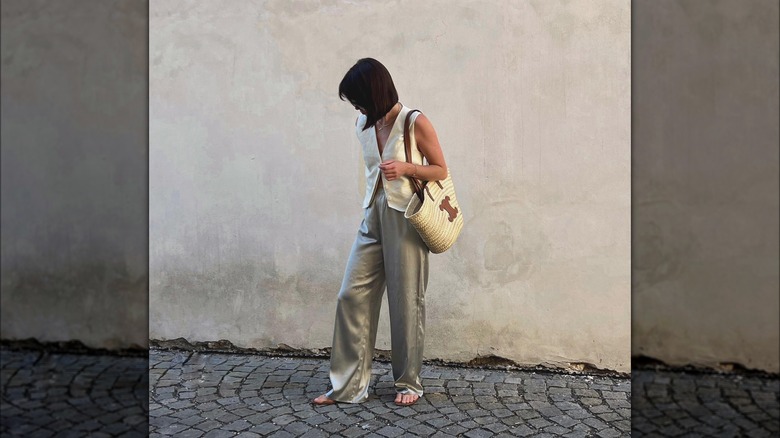 woman in waistcoat and silk trousers