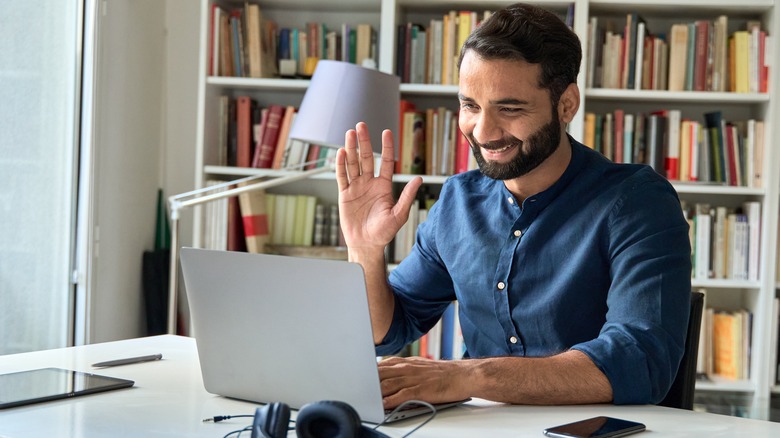 Person smiling at laptop