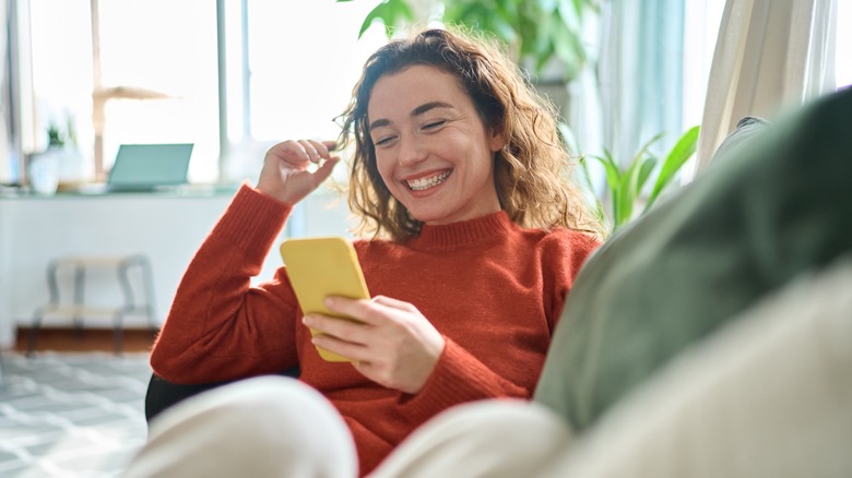 Woman smiling at her phone