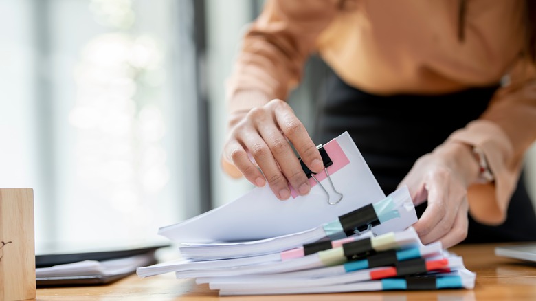 Person going through organized papers