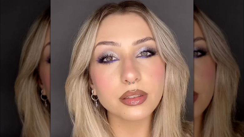 A woman with purple eyeliner
