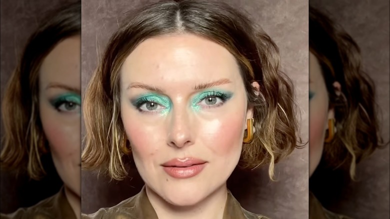 A woman with aquamarine makeup