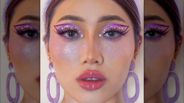 A woman with purple and pink eye makeup