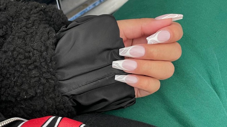 hand with detailed white french manicure