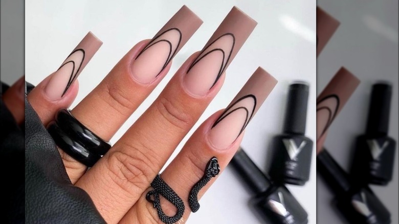 hand with black and beige french manicure