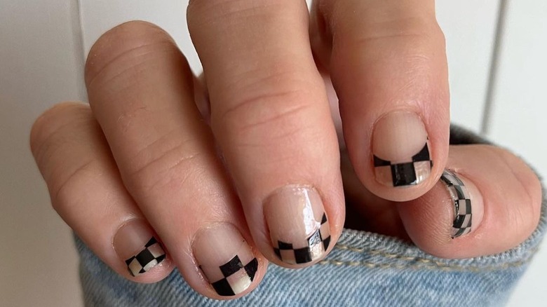 hand with black checkered french manicure