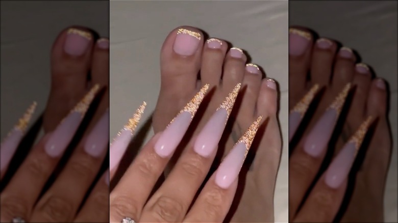 hand and foot with gold french manicure