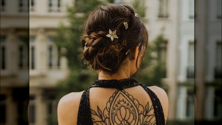 woman hair bun with tattoos 