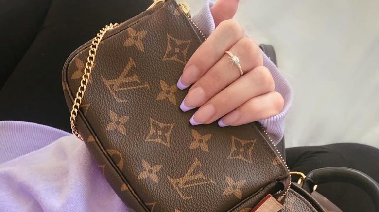 hand with lavender french tip coffin nails