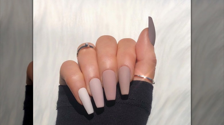 hand with brown coffin nails