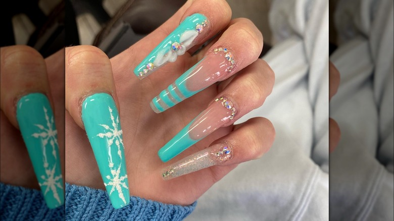 hand with turquoise coffin nails