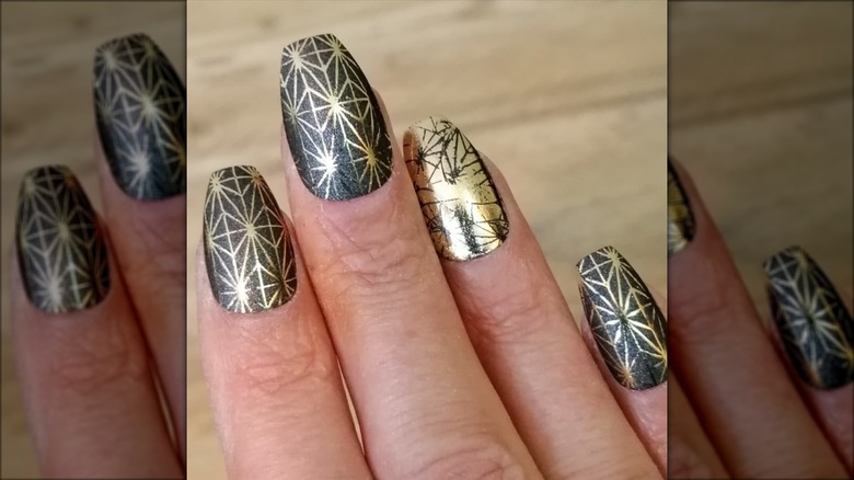 hand with gold foil coffin nails