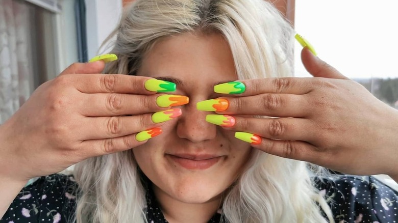 hands with neon coffin nails