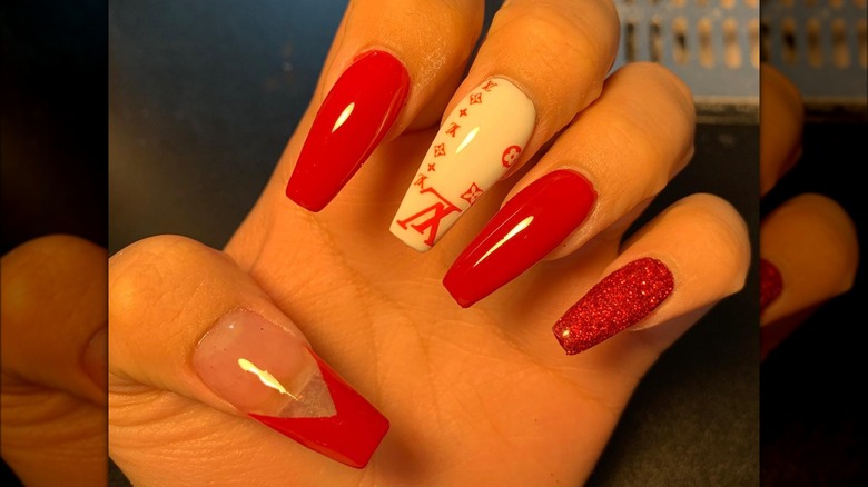 hand with red designer coffin nails