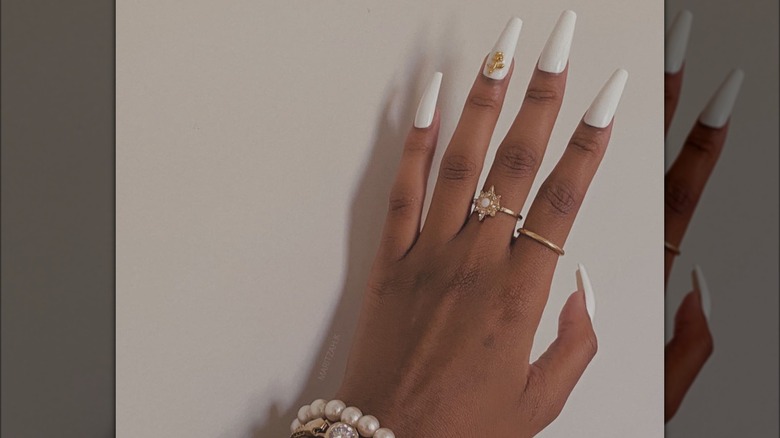 hand with white coffin nails
