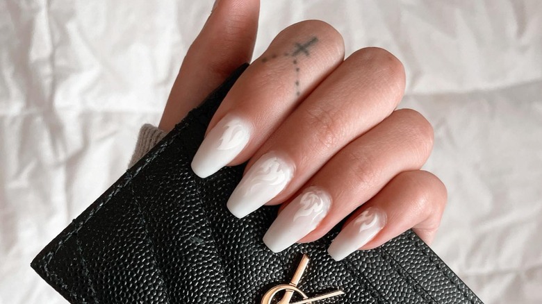 hand with white flames coffin nails