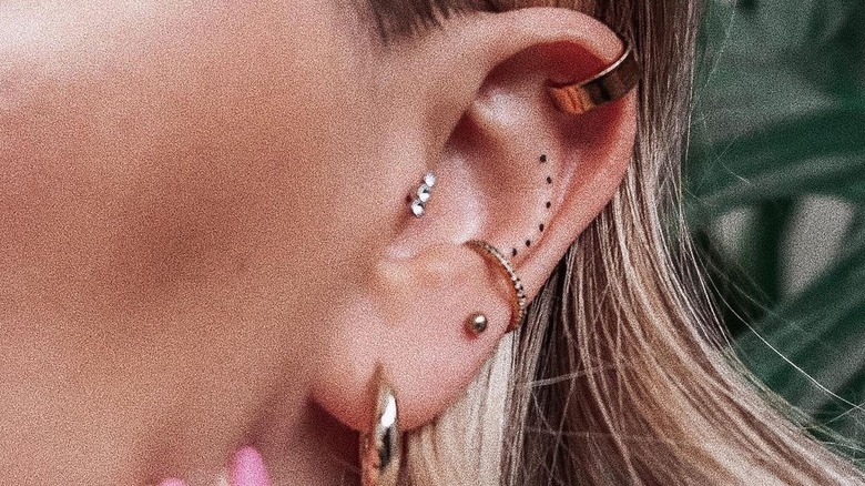 minimalist ear tattoo of dots