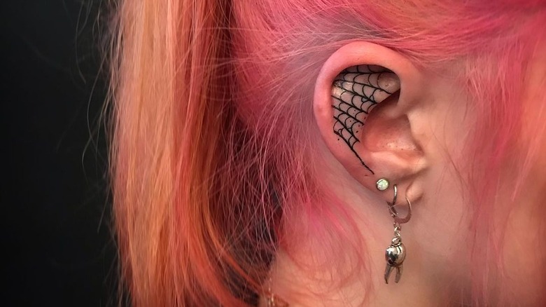 spider web ear tattoo