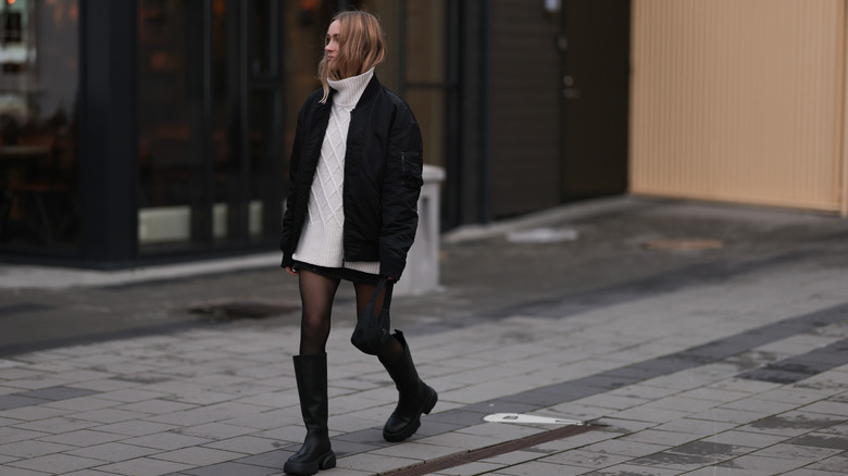 Woman wearing mini dress oversized sweater