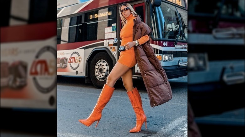Woman wearing mini dress matching boots