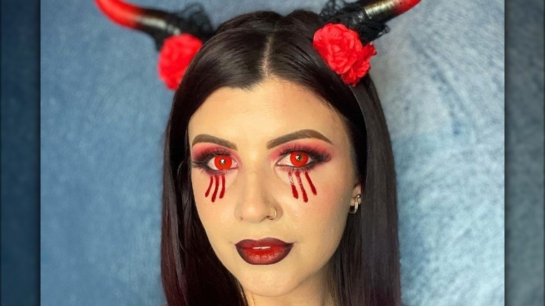 Woman wearing devil makeup