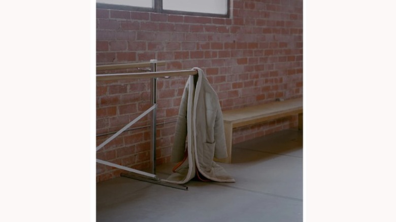 homecoat robe near brick wall