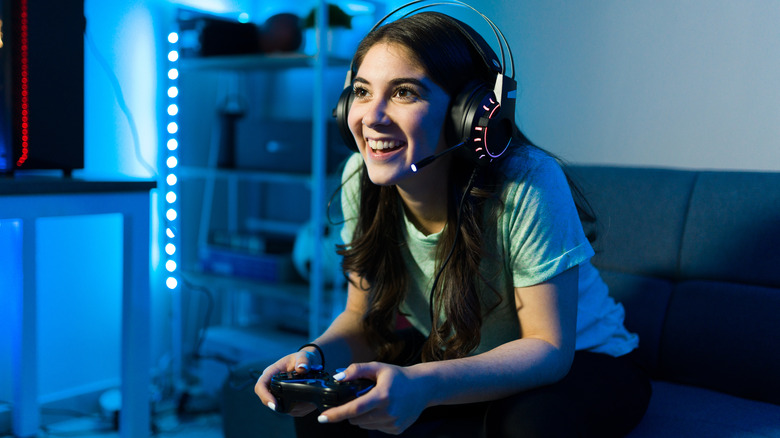 smiling woman video gaming