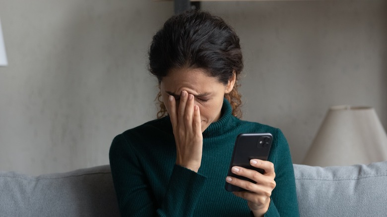 sad woman using phone