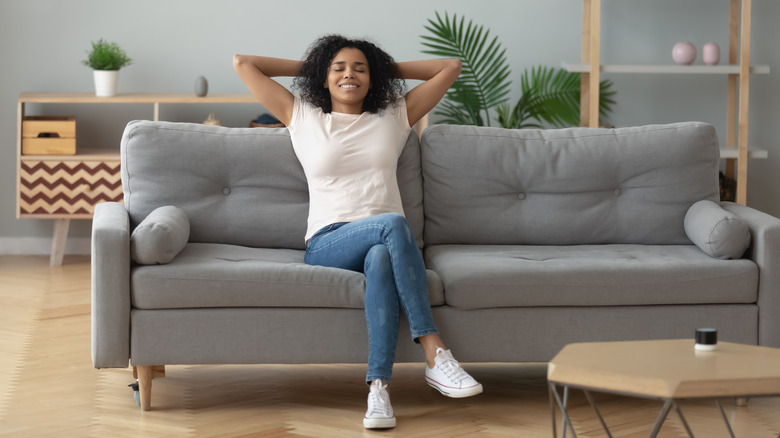 happy woman sitting on couch