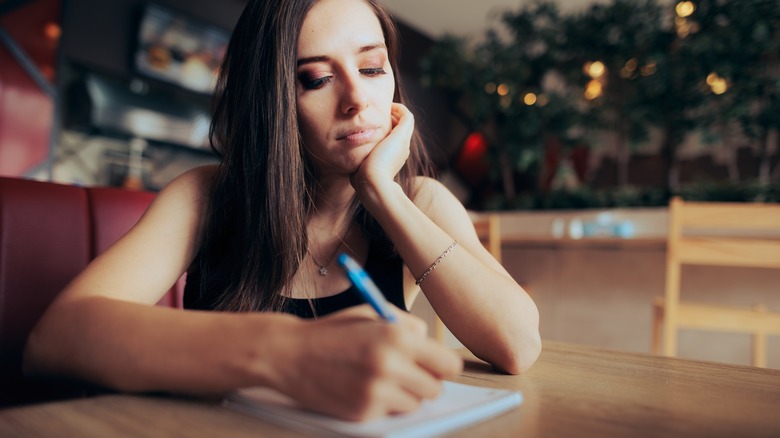 woman writing in journal