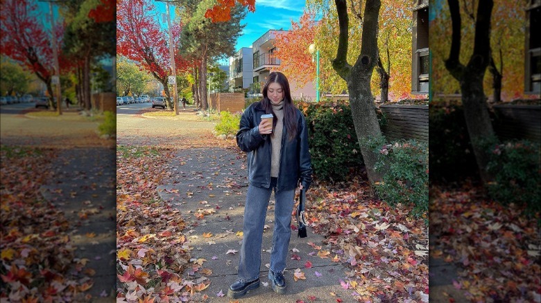 Woman in oversized leather jacket and Doc Martens