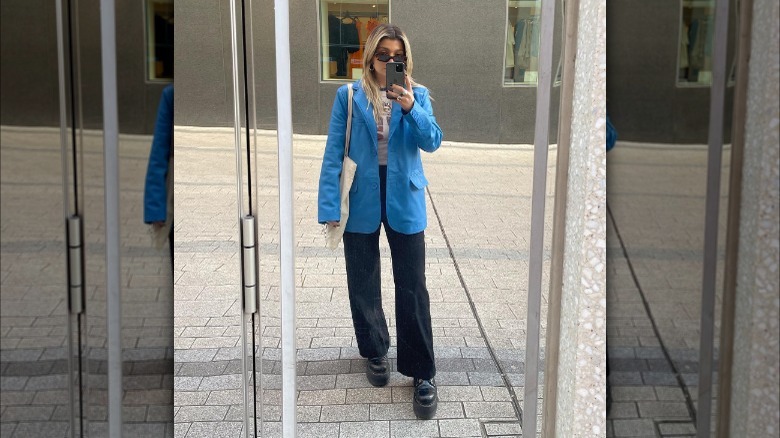 Woman in blue blazer, jeans, and Doc Martens