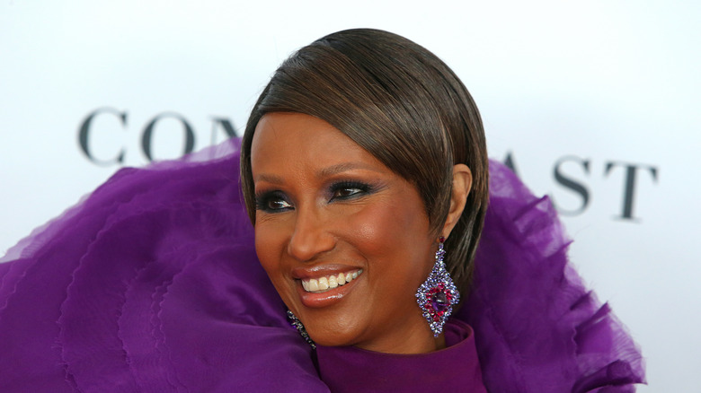 Iman smiling in purple 