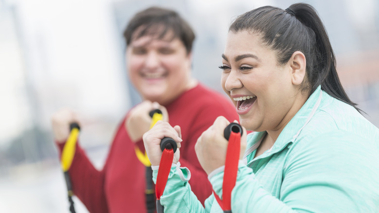 couple doing outdoor fitness class together