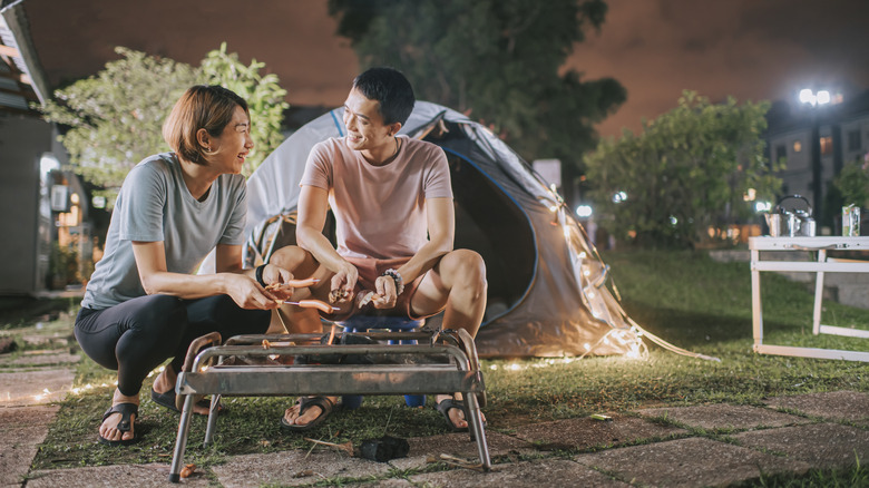 couple camping in backyard