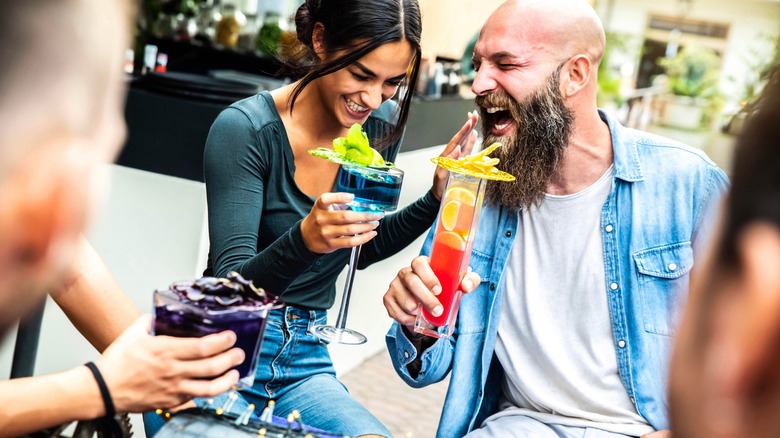 couple drinking cocktails outside