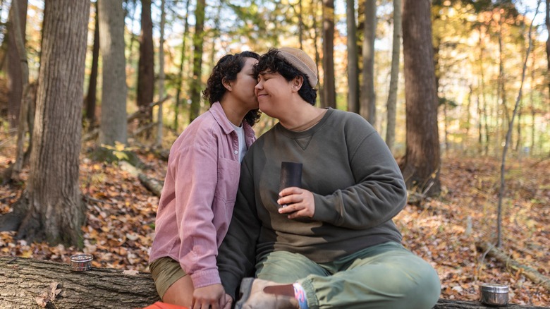 couple sitting in woods 