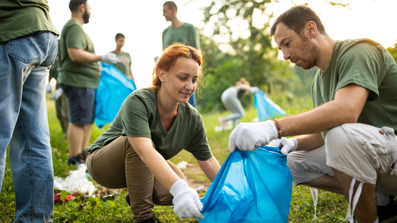 couple collecting trash volunteering together