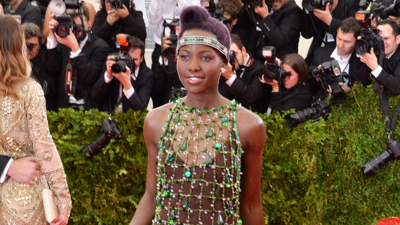 Lupita Nyong'o at Met surrounded by photographers