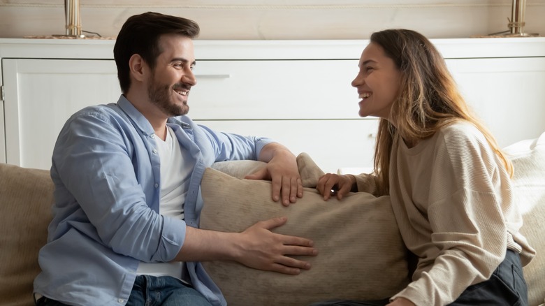 Couple having conversation on sofa