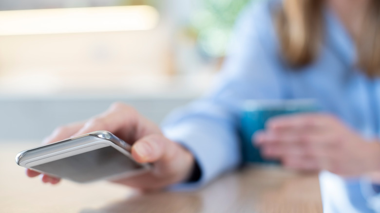 Woman putting phone down