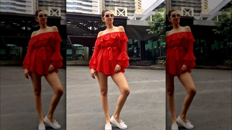 A woman wearing a red romper