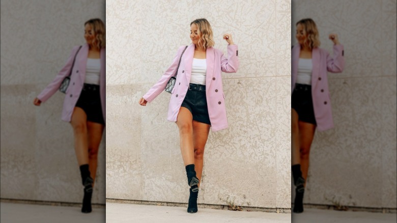 Woman wearing pink blazer with shorts