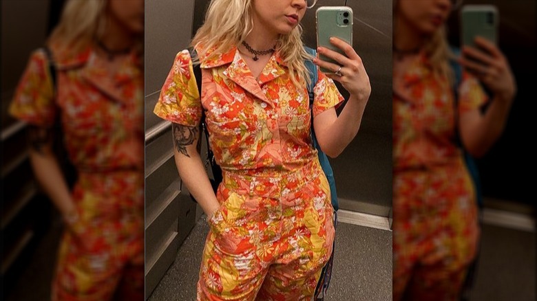 Blonde woman floral orange jumpsuit 