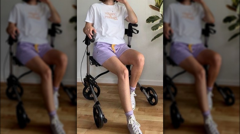 Woman wheelchair embroidered shirt purple shorts