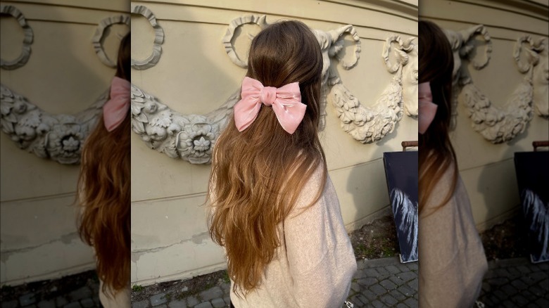 Half-up, half-down hairstyle with bow