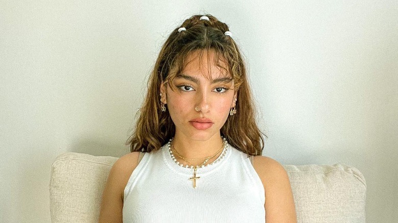 Woman with half-up hairstyle, wispy bangs