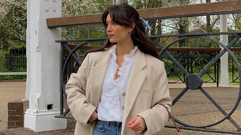 Brunette with Bardot bangs, half-up hairstyle