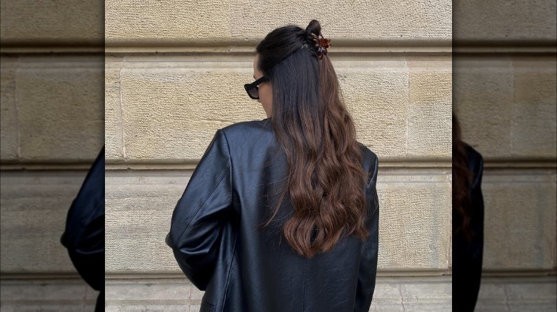 Brunette with half-up hair, claw clip bun